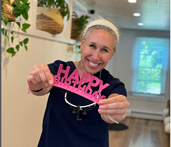 Dental team members in dental office holding roses