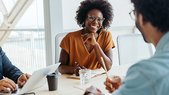 Woman smiling at coworker in meeting