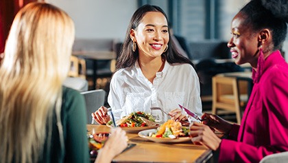 Woman smiling with friends at restaurant